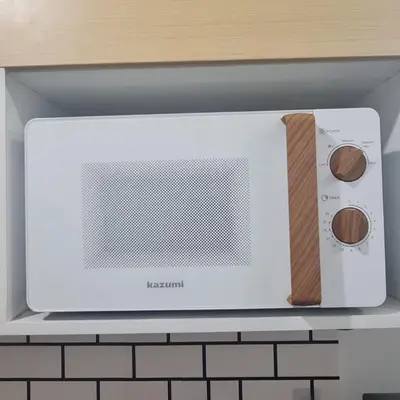 a microwave oven sitting on top of a kitchen counter at Homely - SMDC Green 2 Residences, Dasmarinas City in Pasong Bayog