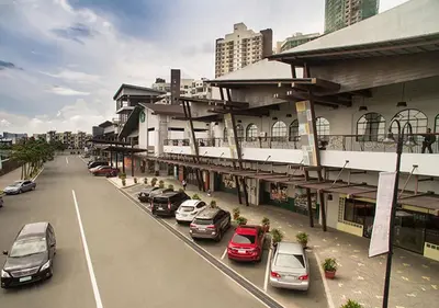 a street with cars parked in front of a building at Fabulous View Circulo Verde, Manila QC in Manila