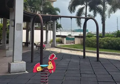 a playground with a toy horse on a swing at Fabulous View Circulo Verde, Manila QC in Manila