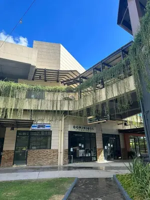 a front view of a building with a donut shop at Modern Comfort Your Gateway to Quezon City One Free Parking in Manila