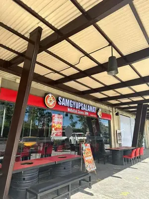 a restaurant with red tables and chairs and a sign at Modern Comfort Your Gateway to Quezon City One Free Parking in Manila