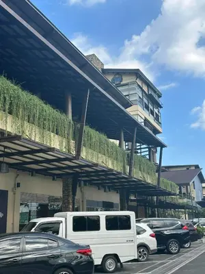 a white truck parked in front of a building at Modern Comfort Your Gateway to Quezon City One Free Parking in Manila