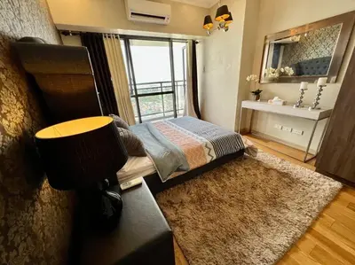 a small bedroom with a bed and a window at The Milano Residences by Versace Stylish 1BR Condo in Manila