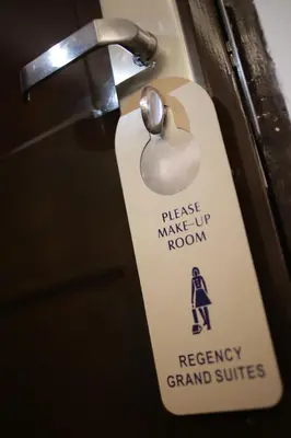 a white door key with a sign on it at Regency Grand Suites in Manila