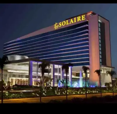 a large building with a siolomo sign on it at Cozy 1 Bedroom with balcony facing pool near MOA,IKEA near in Manila