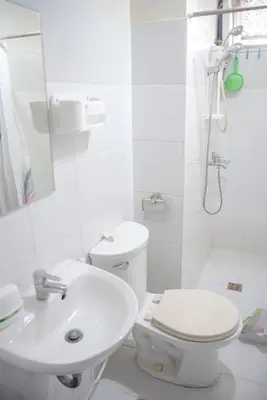 a white bathroom with a toilet and a sink at Spacious 3BR Condo at Little Baguio Terraces San Juan City in Manila