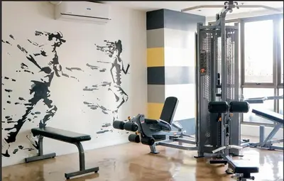 a room with a gym with a wall with birds painted on it at One Bedroom with Netflix at Legaspi Village Makati in Manila