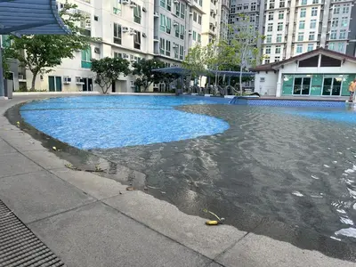 a large pool of water in the middle of a city at Clazzy Home At San Lorenzo in Manila