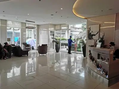 a man standing in the lobby of a building at Sunshine at Grace nr BGC in Manila