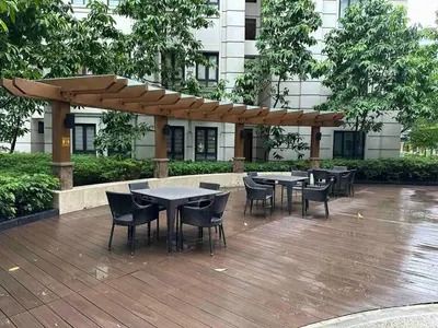 a wooden deck with tables and chairs and a wooden umbrella at NAIA Terminal 3 Insane Interior, Be the Boss in Manila