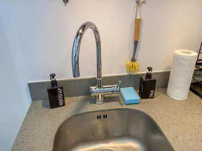a kitchen sink with a faucet on a counter at nJoy! CHIC & Luxury at Venice Grand Canal in Manila