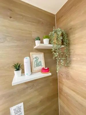 a wall with shelves with plants and a picture at nJoy! CHIC & Luxury at Venice Grand Canal in Manila