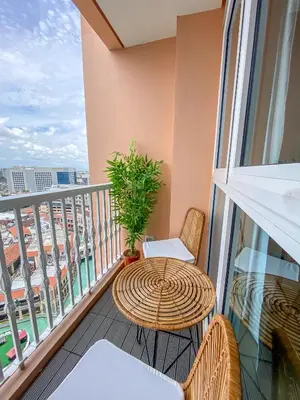 a balcony with a table and chairs and a window at nJoy! CHIC & Luxury at Venice Grand Canal in Manila