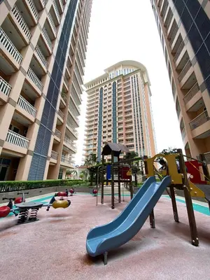a playground in front of a building with a slide at nJoy! CHIC & Luxury at Venice Grand Canal in Manila