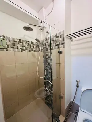 a shower in a bathroom with a glass shower stall at 5th One Bedroom Condo in Grace Residences Taguig in Manila