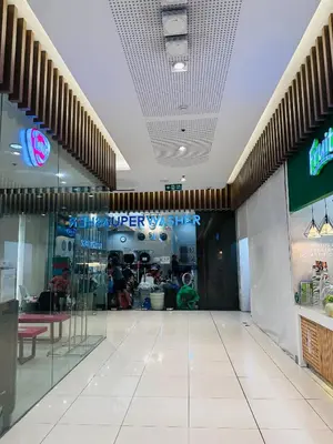 a shopping mall hallway with a sign on the ceiling at 5th One Bedroom Condo in Grace Residences Taguig in Manila