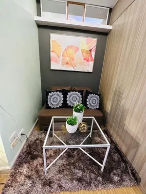a living room with a coffee table and a couch at 5th One Bedroom Condo in Grace Residences Taguig in Manila