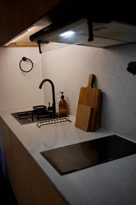 a kitchen counter top with a sink and a stove at NUVALI Amaia Steps Parkway 2 BR Condo THE SANCTUARY with pool, free parking near Carmelray Industrial Park, Ayala Solenad, Xavier School in Pitland