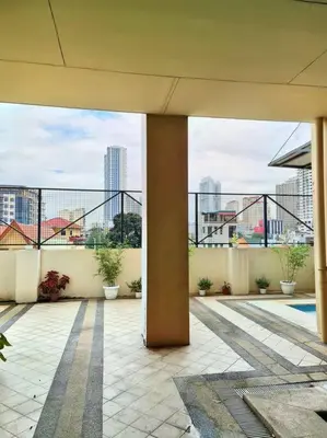 a building with a balcony with a view of a city at Lovely Modern 2BR Condo in Aurora Gardens San Juan City in Manila