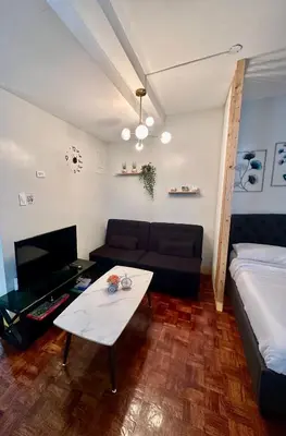 a living room with a couch and a coffee table at L and D Homestay in Manila