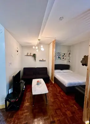 a living room with a bed and a couch at L and D Homestay in Manila