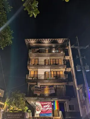 a tall white building with a fire escape at HomeBase Apartment Hotel in Manila