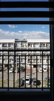 a window with a view of a parking lot with a building at THE FIKA ROOM near MNL Airport - Scandi Studio Unit with Fast Wi-Fi & Netflix - Read Full Property Desc before booking in Manila