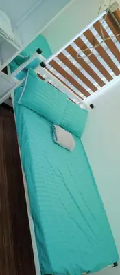 a bunk bed with blue sheets and pillows on a boat at KS RESIDENCES in Manila