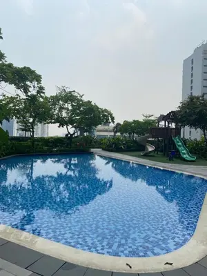 a blue swimming pool with a slide and a playground at Air Residences 1-Bedroom condo in Makati in Manila