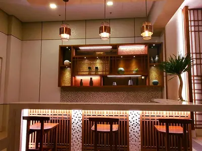 a bar in a restaurant with chairs and lights at mandaluyong 2 br condo for rent in Manila