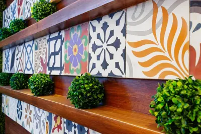 a row of potted plants on a wooden shelf at Nest Nano Suites Poblacion - Makati in Manila
