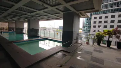 a swimming pool on the roof of a building at ADB Avenue Tower Ortigas Manila in Manila