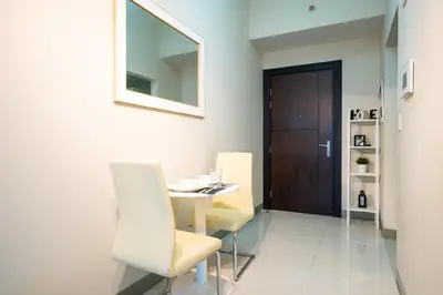 a dining room with a table and two chairs at Uptown Parksuites BGC 1BR, Hi Flr Great view fr Balcony with Washer in Manila