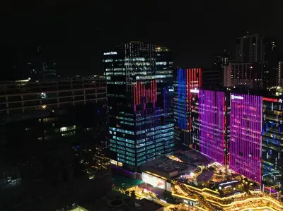 a group of tall buildings lit up at night at Uptown Parksuites BGC 1BR, Hi Flr Great view fr Balcony with Washer in Manila