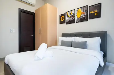a bedroom with a large bed with white sheets at Uptown Parksuites BGC 1BR, Hi Flr Great view fr Balcony with Washer in Manila