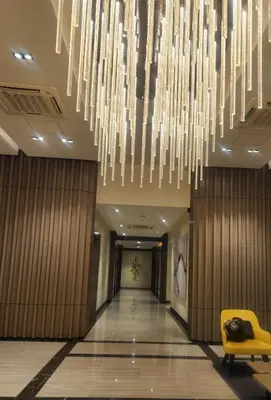 a hallway with a large chandelier in a hotel at 20F Modern Cozy BGC Suite across 2 Major Malls with Washer FREE Parking in Manila