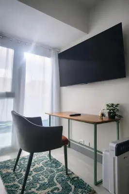 a desk and a chair in a room at 20F Modern Cozy BGC Suite across 2 Major Malls with Washer FREE Parking in Manila