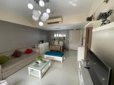a living room with a couch and a table at 150 Newport Blvd - Near T3 Airport in Manila