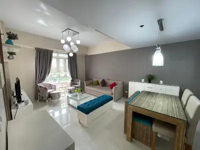 a living room with a couch and a table at 150 Newport Blvd - Near T3 Airport in Manila