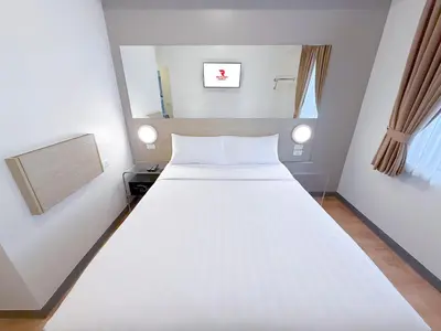 a large white bed in a small room at Red Planet Manila Aseana City in Manila