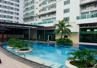 a large swimming pool in front of a building at My Quiet Place at The Beacon - Makati City in Manila