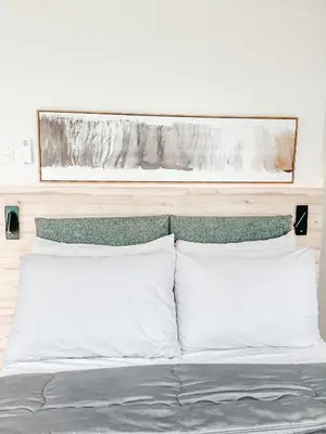 a bed with white pillows in a bedroom at Vibrant Oasis with the best view + Fast WiFi in Manila