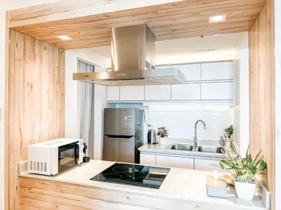 a kitchen with a stove top oven next to a sink at Vibrant Oasis with the best view + Fast WiFi in Manila