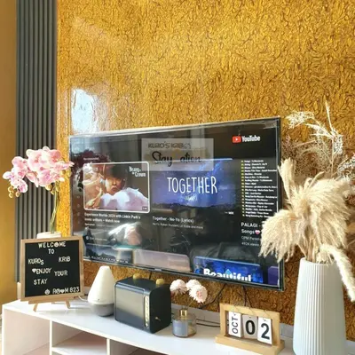a flat screen tv on a yellow wall at Condo in Pasay S Residences in Manila