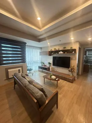 a living room with a couch and a flat screen tv at Exquisite Stays Private 2BR Rental in Manila