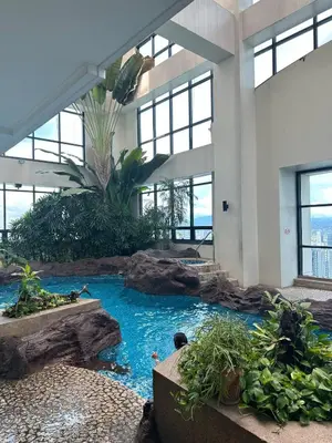 a indoor aquarium in a building with a water slide at Exquisite Stays Private 2BR Rental in Manila