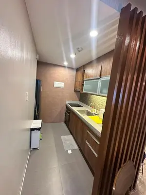 a small kitchen with a sink and a counter at Exquisite Stays Private 2BR Rental in Manila