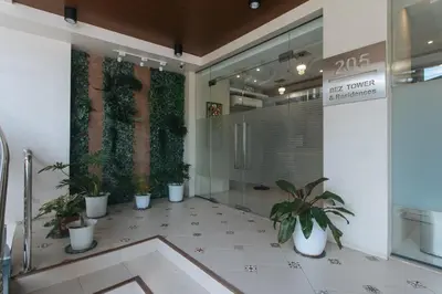 a lobby with potted plants in a building at RedDoorz Plus @ Bez Tower and Residences San Juan in Manila