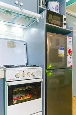 a kitchen with an oven and a refrigerator at Casa Jessica 329 Dubai style One bedroom Corner unit in Bacoor