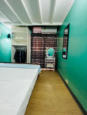 a room with a bed and a green wall at Casa Jessica 329 Dubai style One bedroom Corner unit in Bacoor
